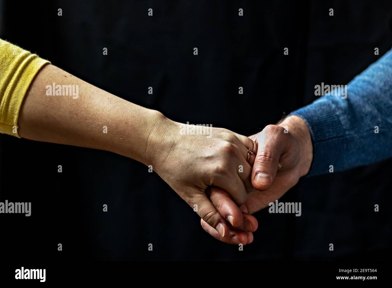 Giovane coppia che tiene le mani mostrando amore e cura, marito e moglie sono teneramente vicini insieme, mostrando sostegno e comprensione. Foto Stock