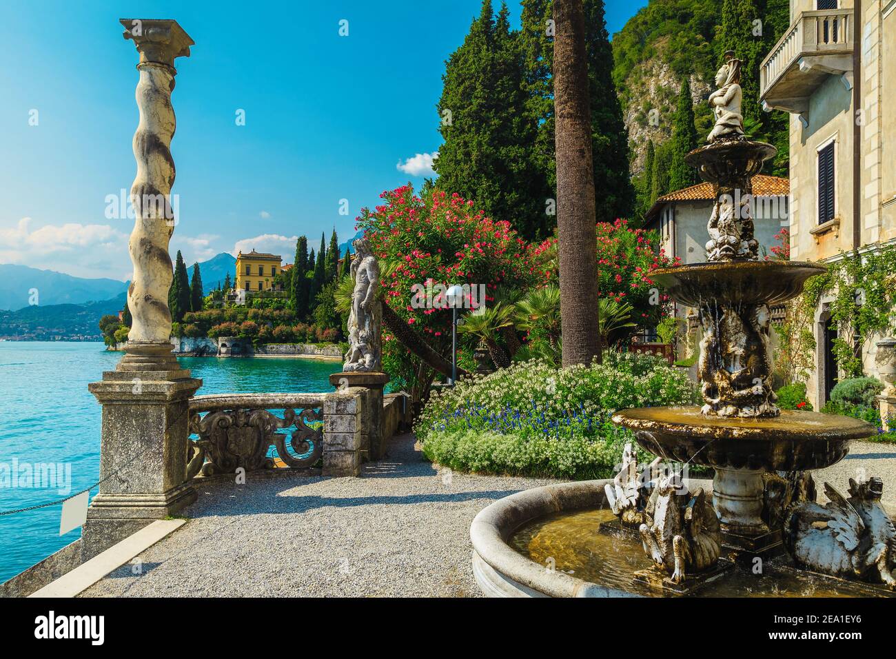 Splendida villa di vacanza fronte mare e giardino ornamentale. Vari fiori colorati e fontana nel giardino di villa Monastero, lago di Como, Lombardia, Foto Stock