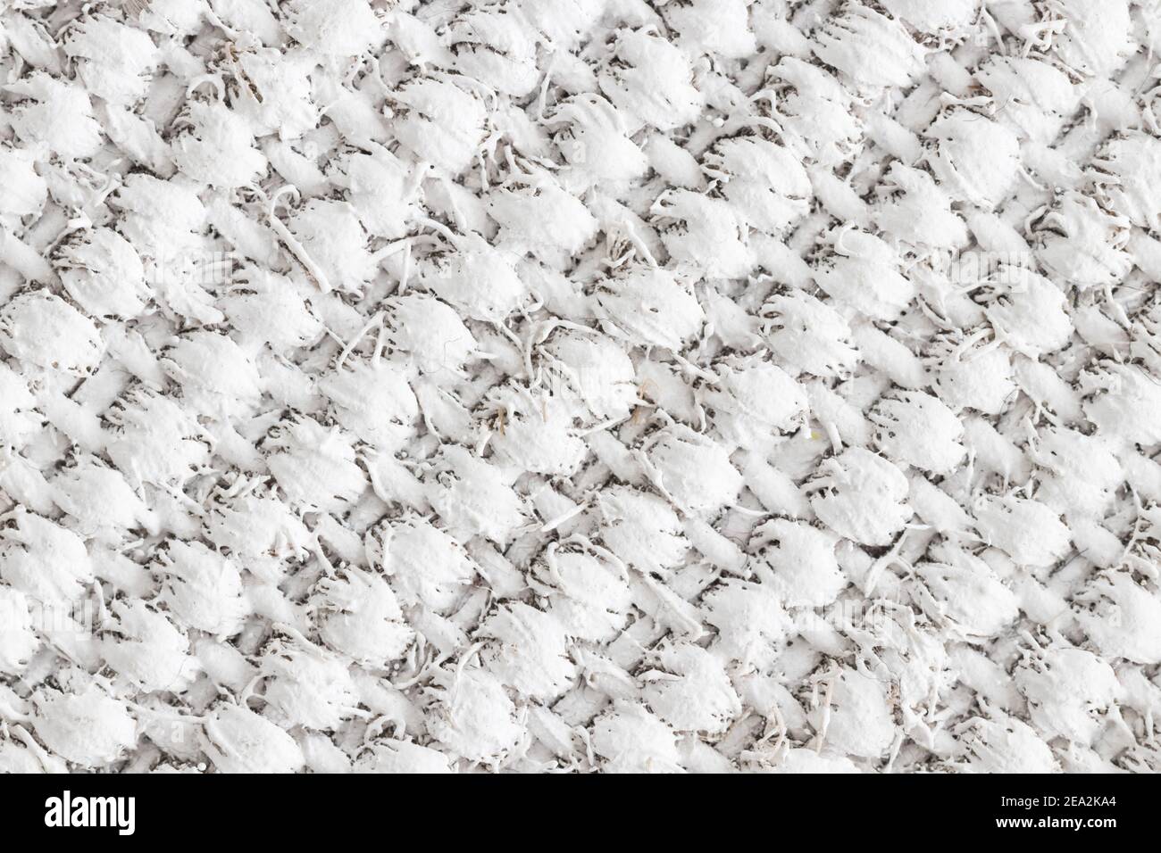 Disegno diagonale di un tappeto di lamella tessuto verniciato bianco. Foto Stock