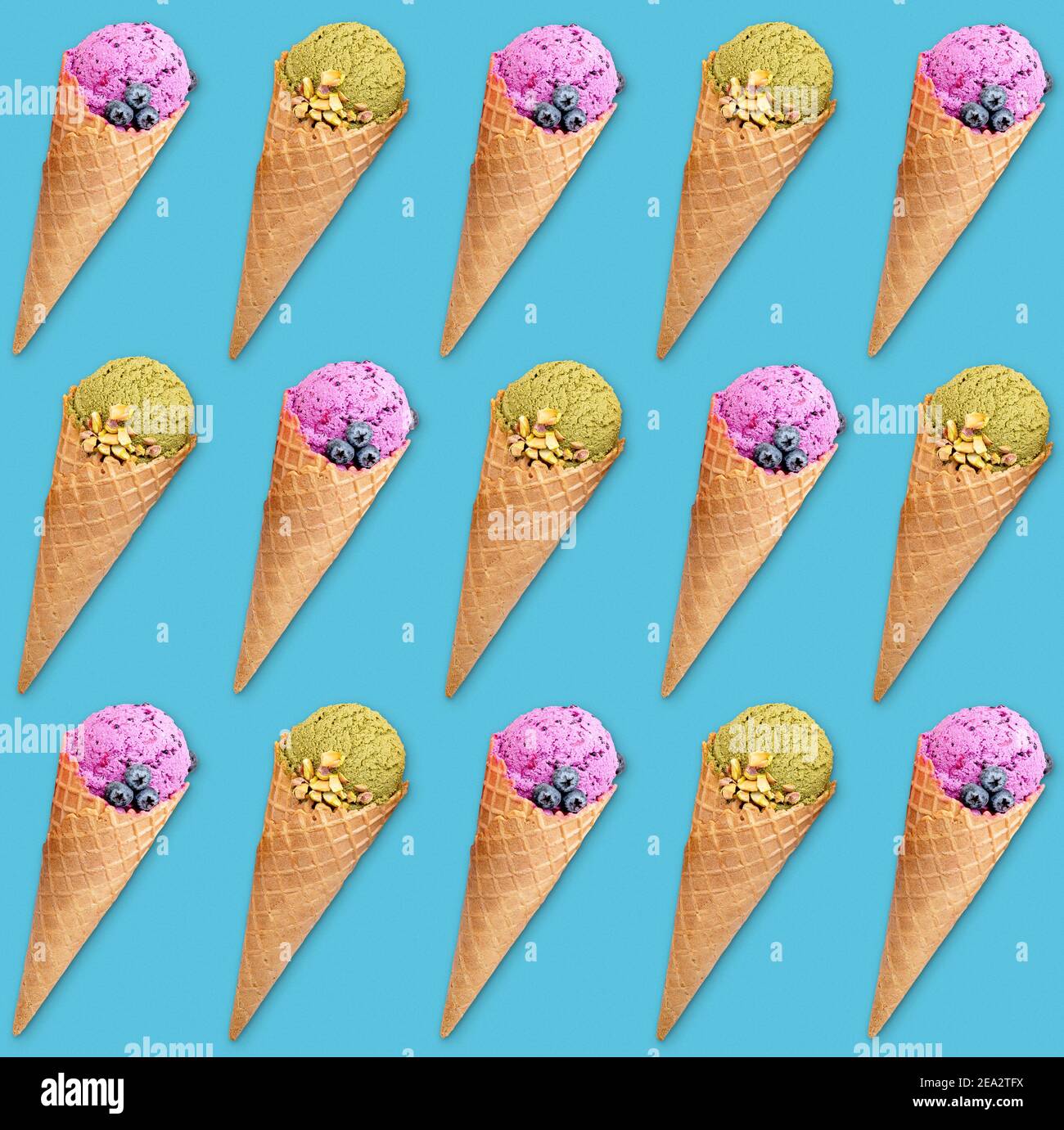 Disposizione simmetrica di coni gelato su sfondo turchese, colorato modello di cibo dolce Foto Stock
