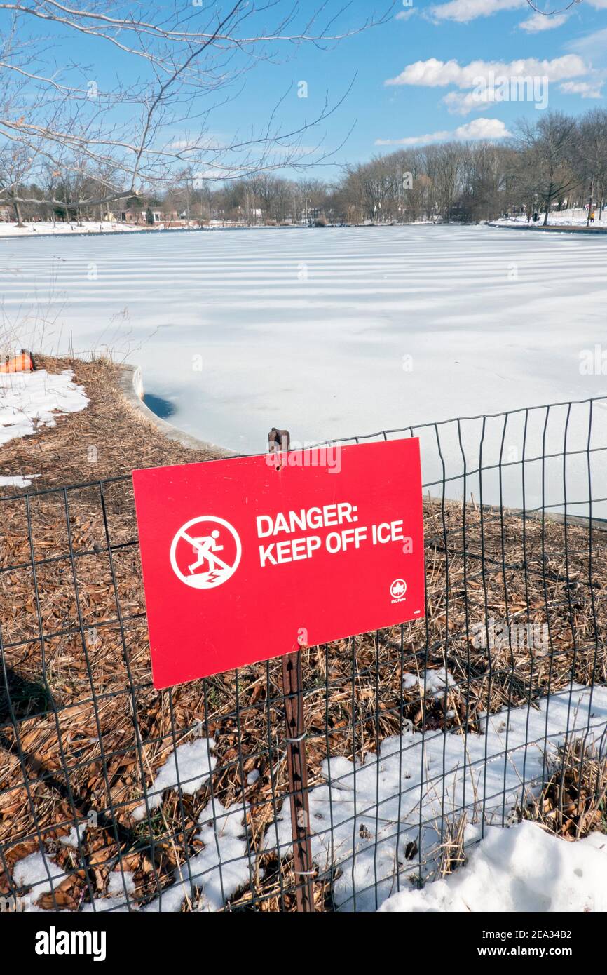 Un cartello nel Parco di Kissena che avvisa la gente di non andare sul ghiaccio quando il lago si blocca. A Flushing, Queens, New York City. Foto Stock
