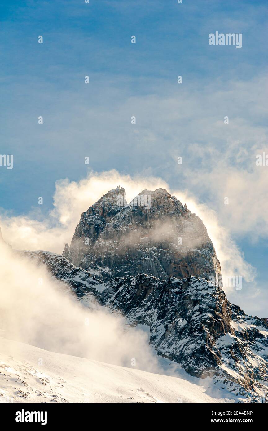 Forte tempesta vento guidando su nubi di neve intorno alla cima Del Les Drus in Argentiere Chamonix Francia Foto Stock