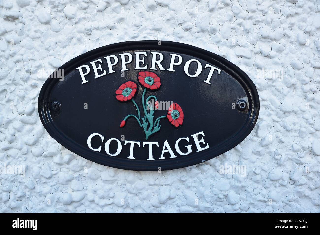 Targa fissa al muro della casa di nome Pepperpot Cottage Foto Stock
