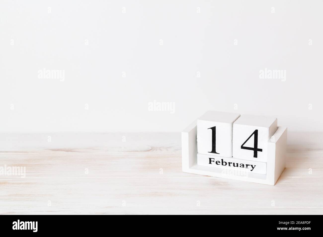 Calendario in legno che mostra di Febbraio 14 su sfondo bianco. San Valentino. Stile vintage. Spazio di copia. Messa a fuoco selettiva. Foto Stock