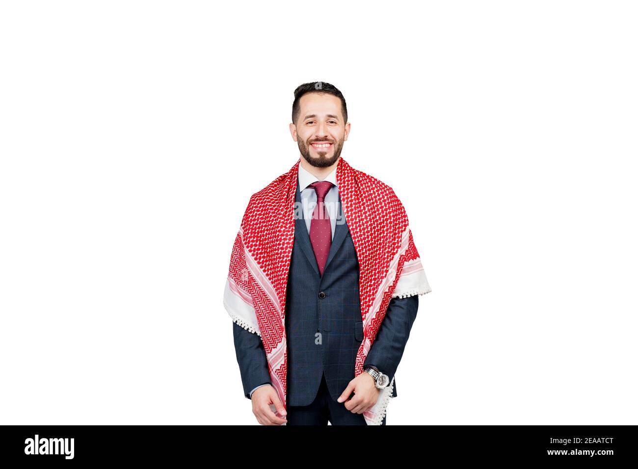 Bell'uomo d'affari arabo in tuta e shemagh sorride su sfondo bianco in studio. Ritratto di affari dell'uomo riuscito Foto Stock