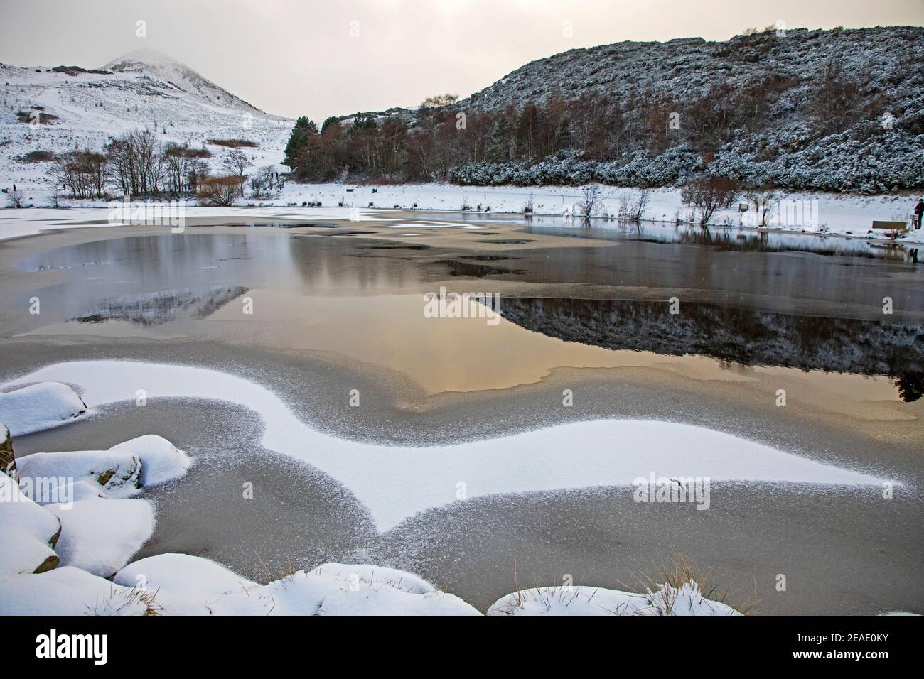 Holyrood Park, Edimburgo, Scozia, Regno Unito. 9 febbraio 2021. È un uccello, è un aereo? Nella foto: Dunsapie Loch con un disegno interessante sulla superficie lasciata dalla caduta di neve e l'acqua dal lago. Foto Stock