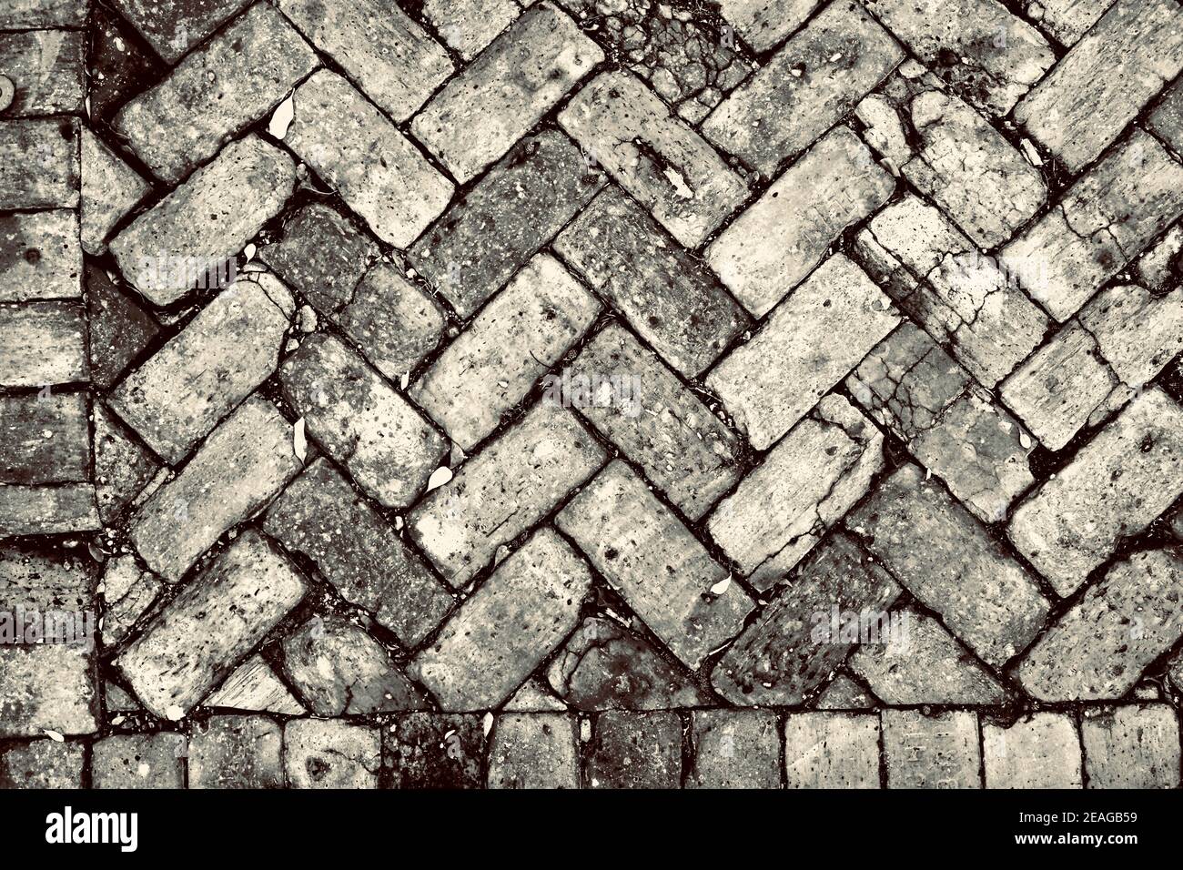 Mattoni a spina di pesce in Key West, Florida, Florida USA. Invecchiato, alterato, punto più meridionale negli Stati Uniti continentali. Isola destinazione di vacanza Foto Stock