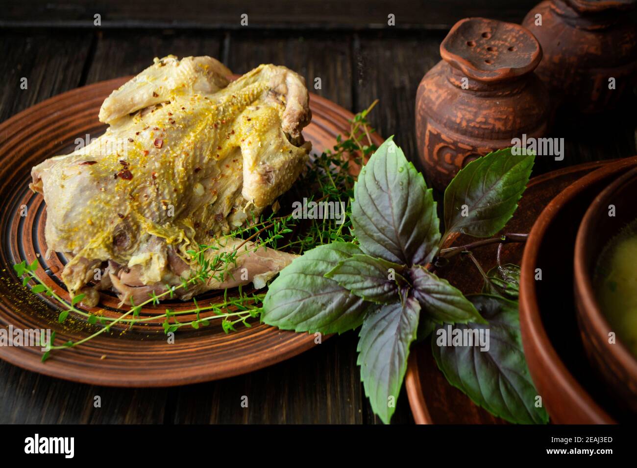 pasto arrosto in pernice su tavola rustica e piatto marrone Foto Stock