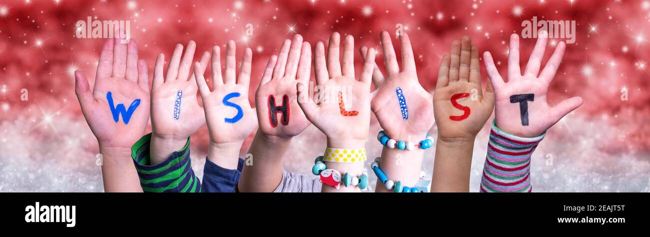 I bambini mani costruire parola Wishlist, sfondo rosso Natale Foto Stock