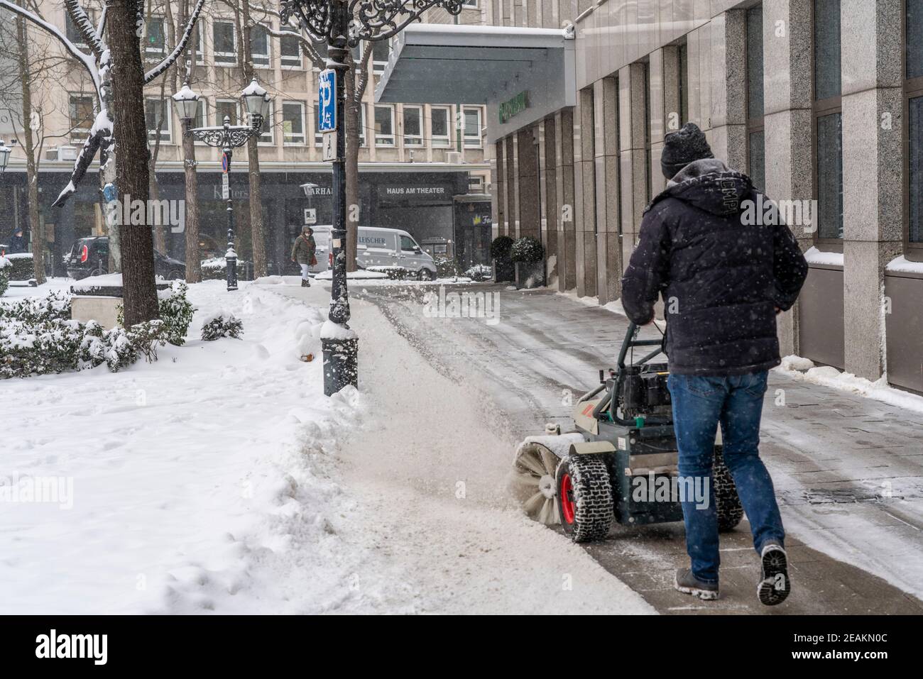Servizio invernale privato, neve che spazia di fronte a un edificio commerciale nel centro della città di Essen, Kettwiger Strasse, inizio inverno, un sacco di sn fresco Foto Stock