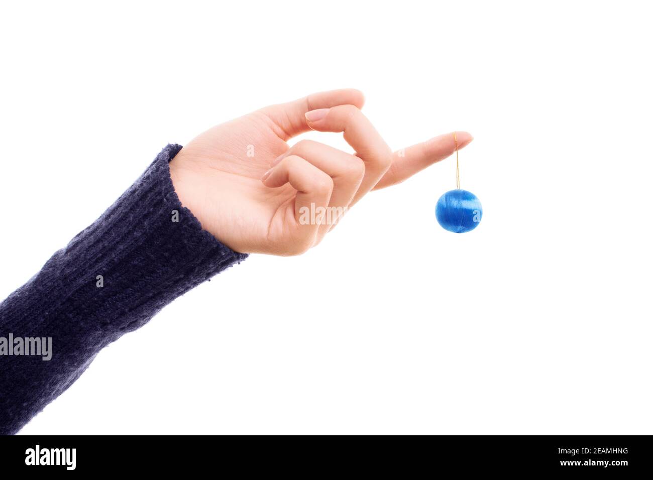 Mano femminile che tiene un ornamento della sfera di Natale Foto Stock