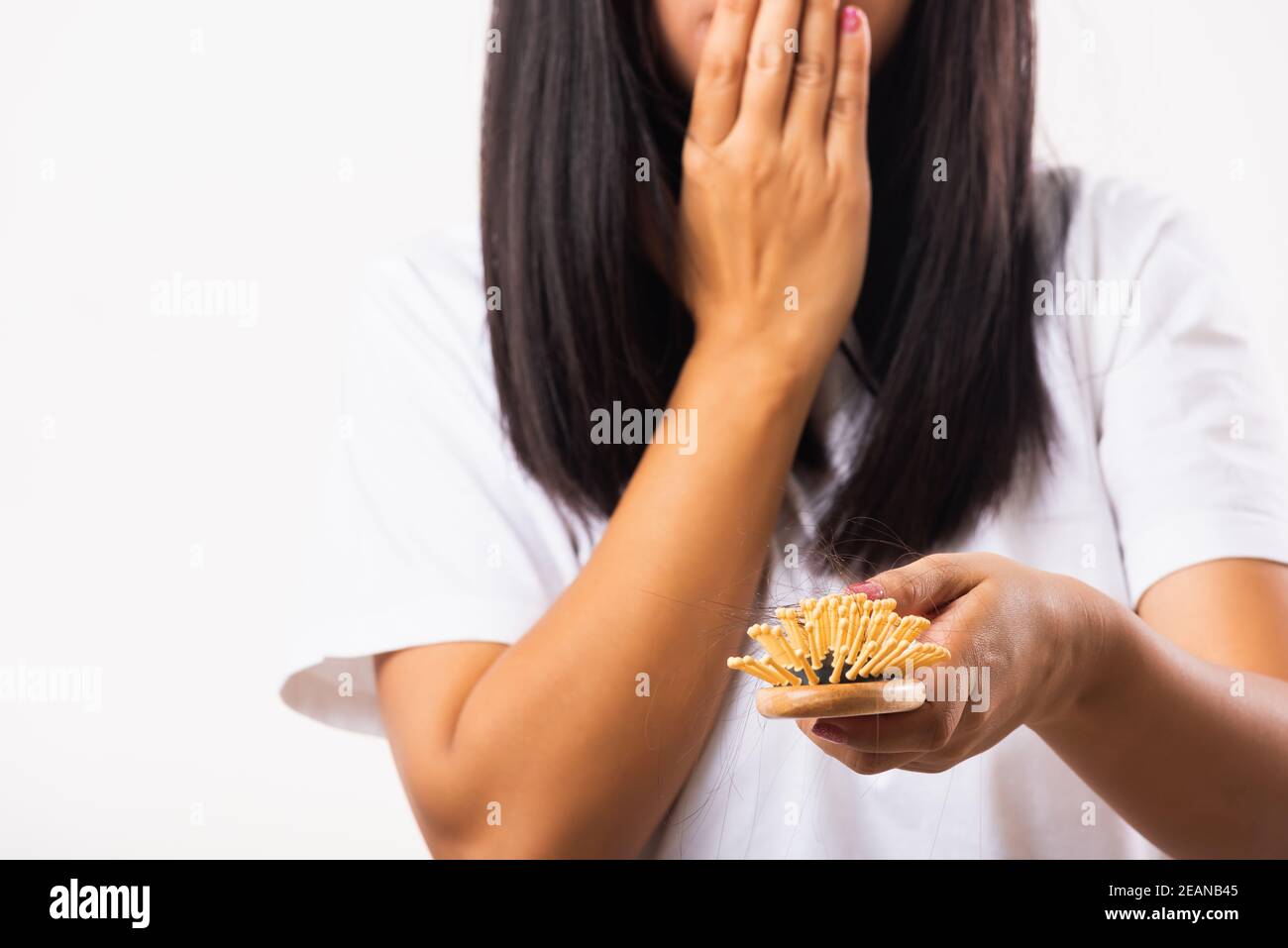Donna debole capelli problema suo tenere capelli spazzola con danneggiato lungo lancetta i capelli nella spazzola del pettine sulla mano Foto Stock