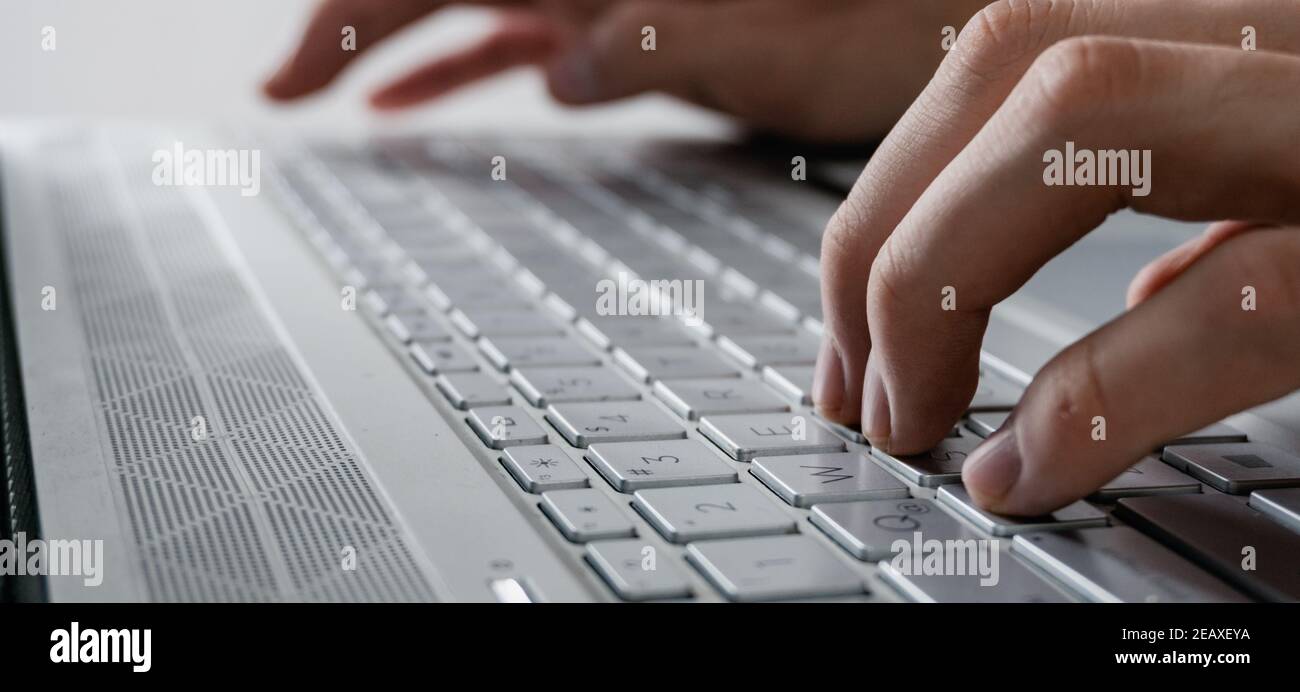 le mani dell'uomo scrivendo su un computer moderno tutto grigio, foto senza sfondo Foto Stock