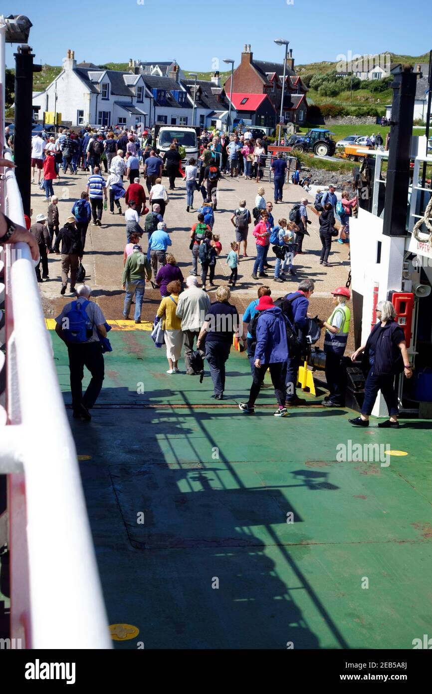 I passeggeri che sbarcano a Iona dal Mull al traghetto per Iona Nelle Ebridi interne della Scozia Foto Stock