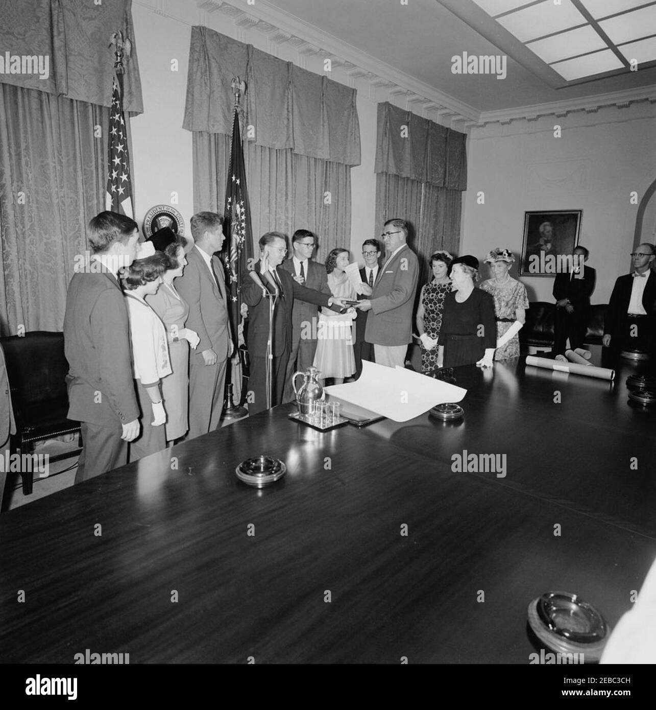 Cerimonia di giuramento, James Ramey u0026 John Palfrey, membri della Commissione per l'energia atomica (AEC), 12:30. Il presidente John F. Kennedy ed altri osservano come James T. Ramey e John G. Palfrey sono giurati dentro come membri della Commissione di energia atomica (AEC); assistente esecutivo Clerk della Casa Bianca, Herbert L. Miller, amministra il giuramento. Da sinistra a destra: James N. Ramey; Drucilla Ramey; Dr. Estelle R. Ramey; Presidente Kennedy; nuovi commissari AEC, James T. Ramey e John G. Palfrey; Clochette Roosevelt Palfrey; John G. u0022Seanu0022 Palfrey, Jr.; Miller; Sarah Palfrey Danzig; Foto Stock