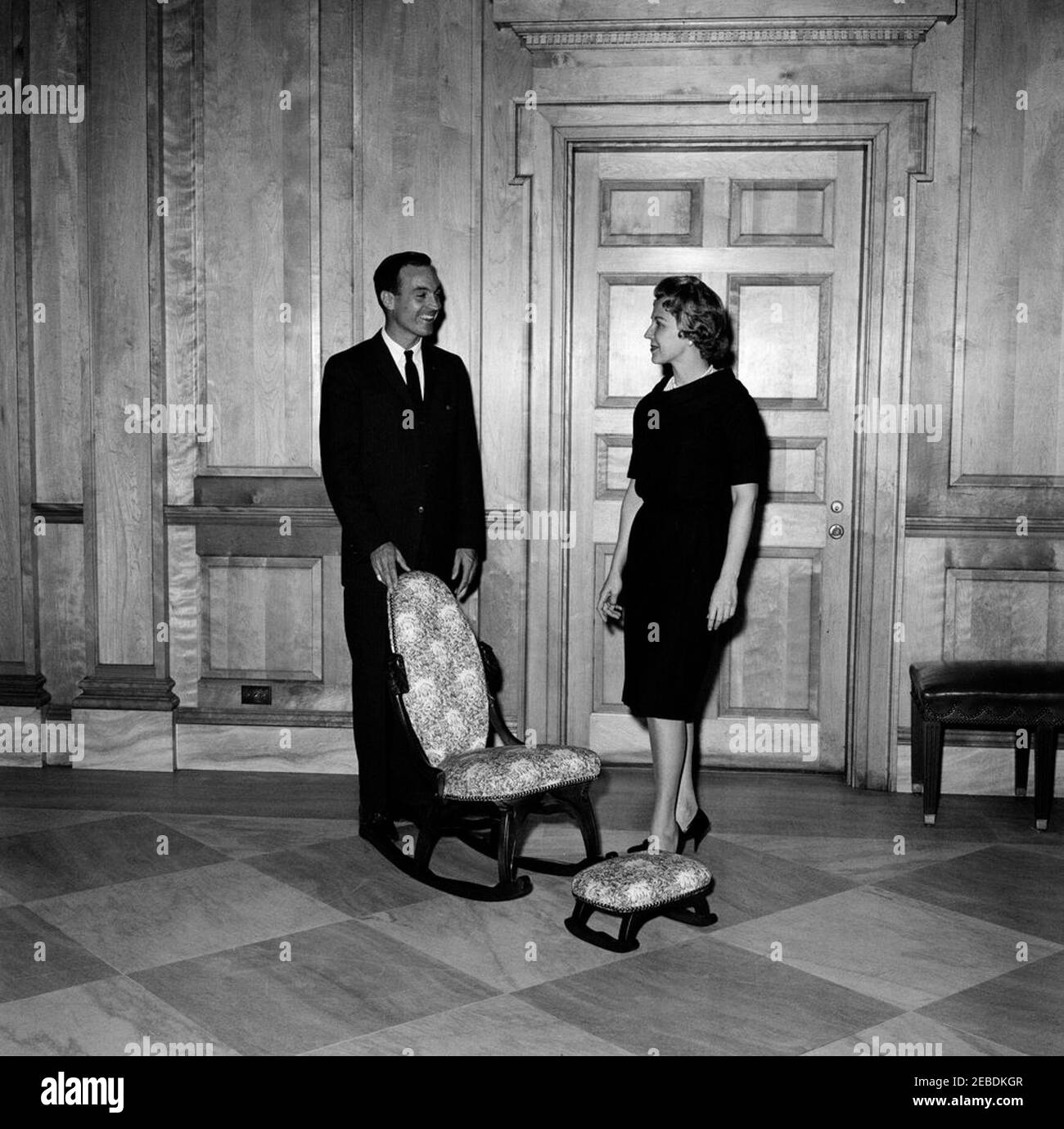 Sedia a dondolo donata alla Casa Bianca. Sedia a dondolo con poggiapiedi donata alla Casa Bianca da Memphis, Tennessee, Camera di Commercio Junior. Due membri dello staff della Casa Bianca non identificati. La lobby dell'Ala Est, la Casa Bianca, Washington, D.C. Foto Stock