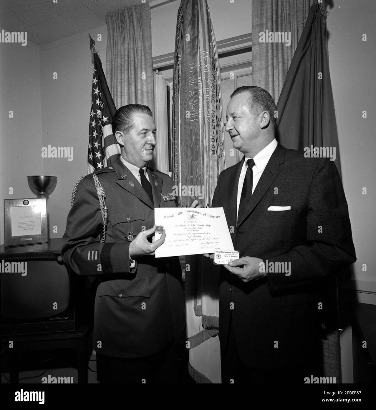 Military Aide al Presidente Gen. Chester V. Clifton accetta il certificato di adesione della National Rifle Association (NRA) per il Presidente Kennedy di Franklin L. Orth, Vice Presidente Esecutivo della NRA. Vicepresidente esecutivo della National Rifle Association (NRA) Franklin L. Orth presenta al presidente Chester V. Clifton alla Casa Bianca, Washington, D.C. il certificato di adesione della NRA e la tessera per il presidente John F. Kennedy alla Military Aide. Il generale Clifton ha accettato l'adesione per conto del presidente. Foto Stock