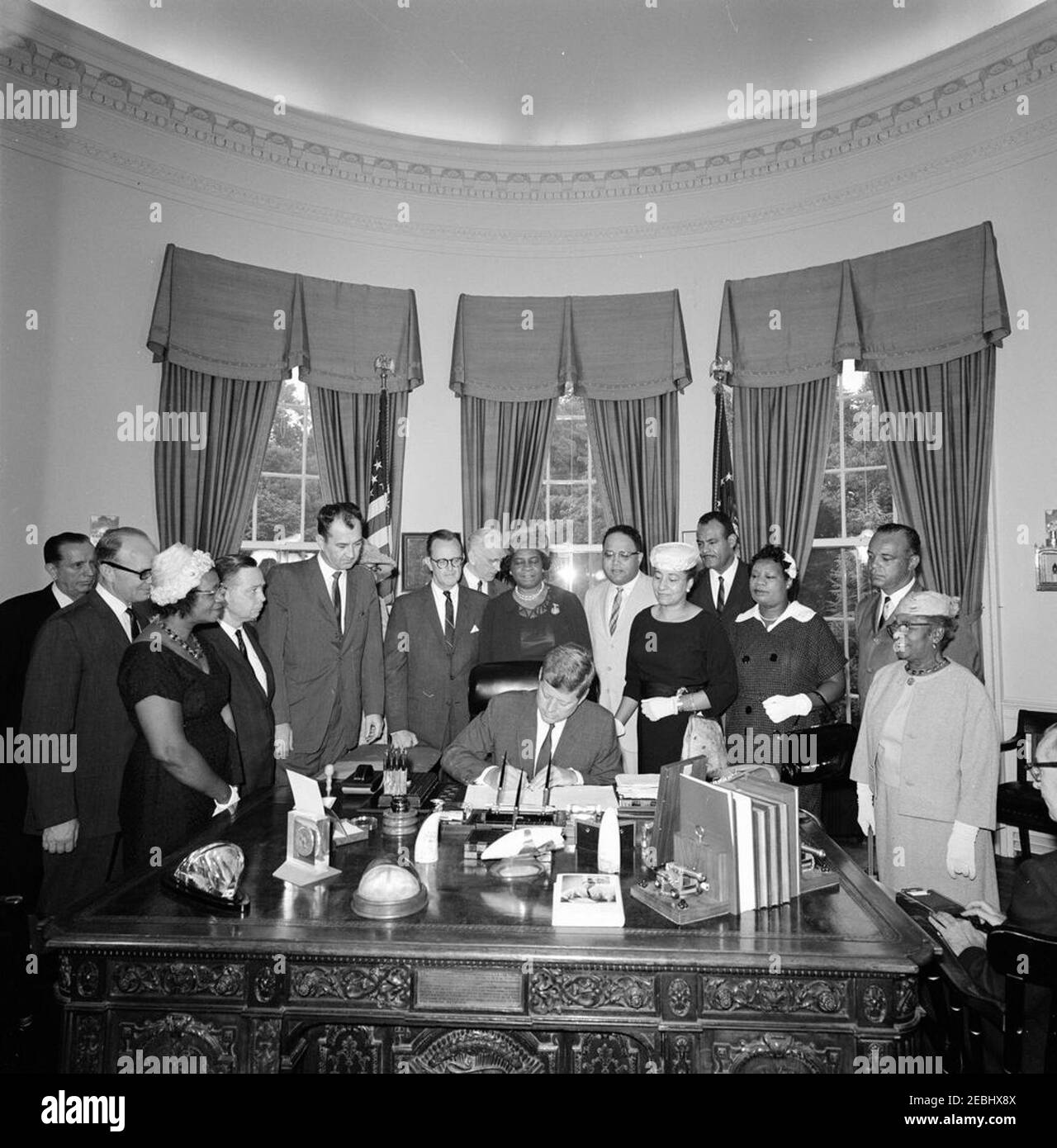 2399 Legge pubblica 87-633, designazione della casa di Frederick Douglass come parte del sistema del Parco nella capitale Nazionale, 9:45 AM. Il presidente John F. Kennedy firma una legge che designa la casa di Frederick Douglassu2019 come parte del sistema del parco nazionale nella capitale nazionale. In piedi (L-R): Ex Segretario dell'interno, Oscar L. Chapman; Segretario aggiunto dell'interno per la gestione delle terre pubbliche, John A. Carver; Presidente del Consiglio di amministrazione della sede centrale del D.C. dell'Associazione Nazionale dei Club Womenu2019s colorati (NACWC), Georgia Anderson; Rappresentante Carl Albert (Oklaho Foto Stock