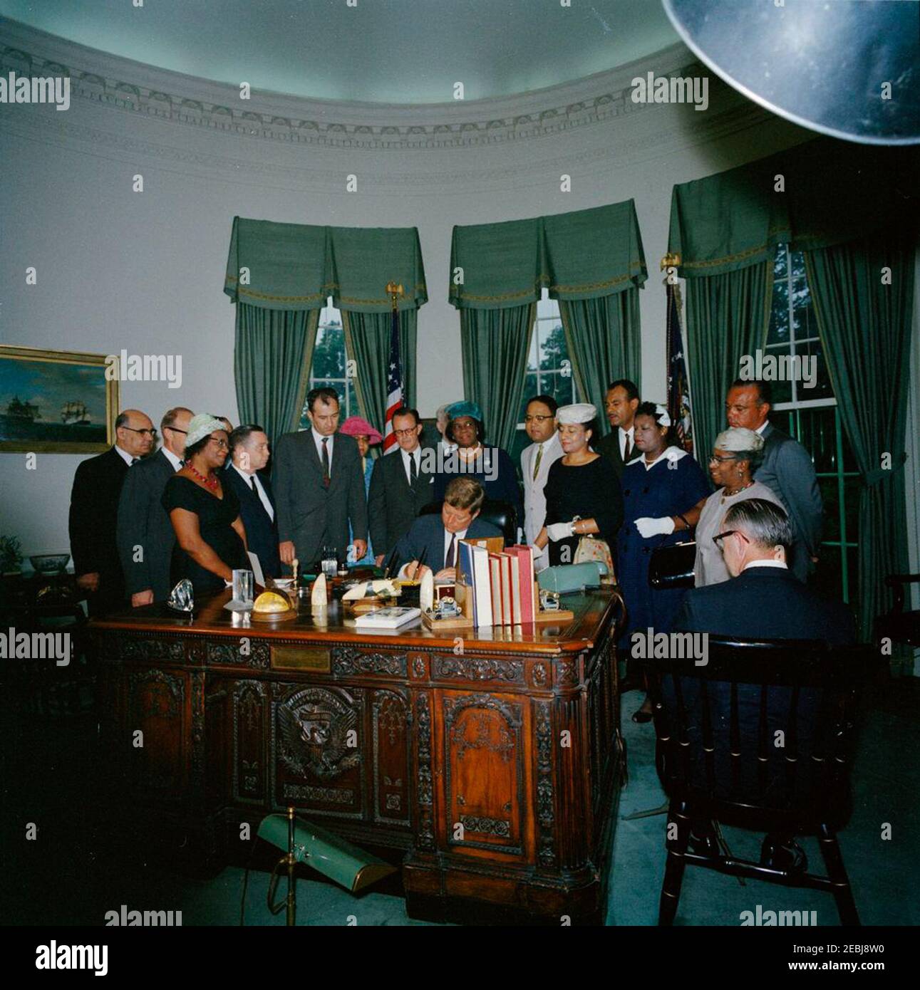 2399 Legge pubblica 87-633, designazione della casa di Frederick Douglass come parte del sistema del Parco nella capitale Nazionale, 9:45 AM. Il presidente John F. Kennedy firma una legge che designa la casa di Frederick Douglassu2019 come parte del sistema del parco nazionale nella capitale nazionale. Standing (L-R): Presidente Emerito della Howard University, Mordechai W. Johnson; Vice Segretario dell'interno per la gestione delle terre pubbliche, John A. Carver (volto oscurato); Presidente del Consiglio di amministrazione della D.C. dell'Associazione Nazionale dei Club Womenu2019s colorati (NACWC), Georgia Anderson; repressen Foto Stock
