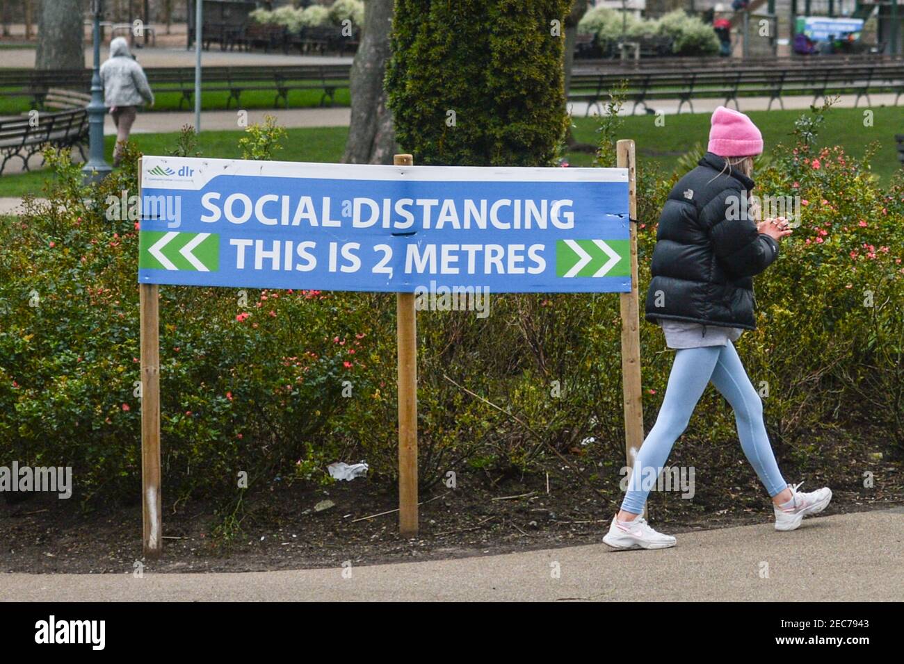 Dublino, Irlanda. 11 Feb 2021. Una donna cammina oltre un segno sociale di allontanamento nella zona di Laoghaire D?n durante le restrizioni di livello 5 Covid-19. Il Dipartimento della Salute ha riferito il 11 febbraio 2021, un totale di 862 nuovi casi COVID-19 e 52 decessi. Credit: SOPA Images Limited/Alamy Live News Foto Stock
