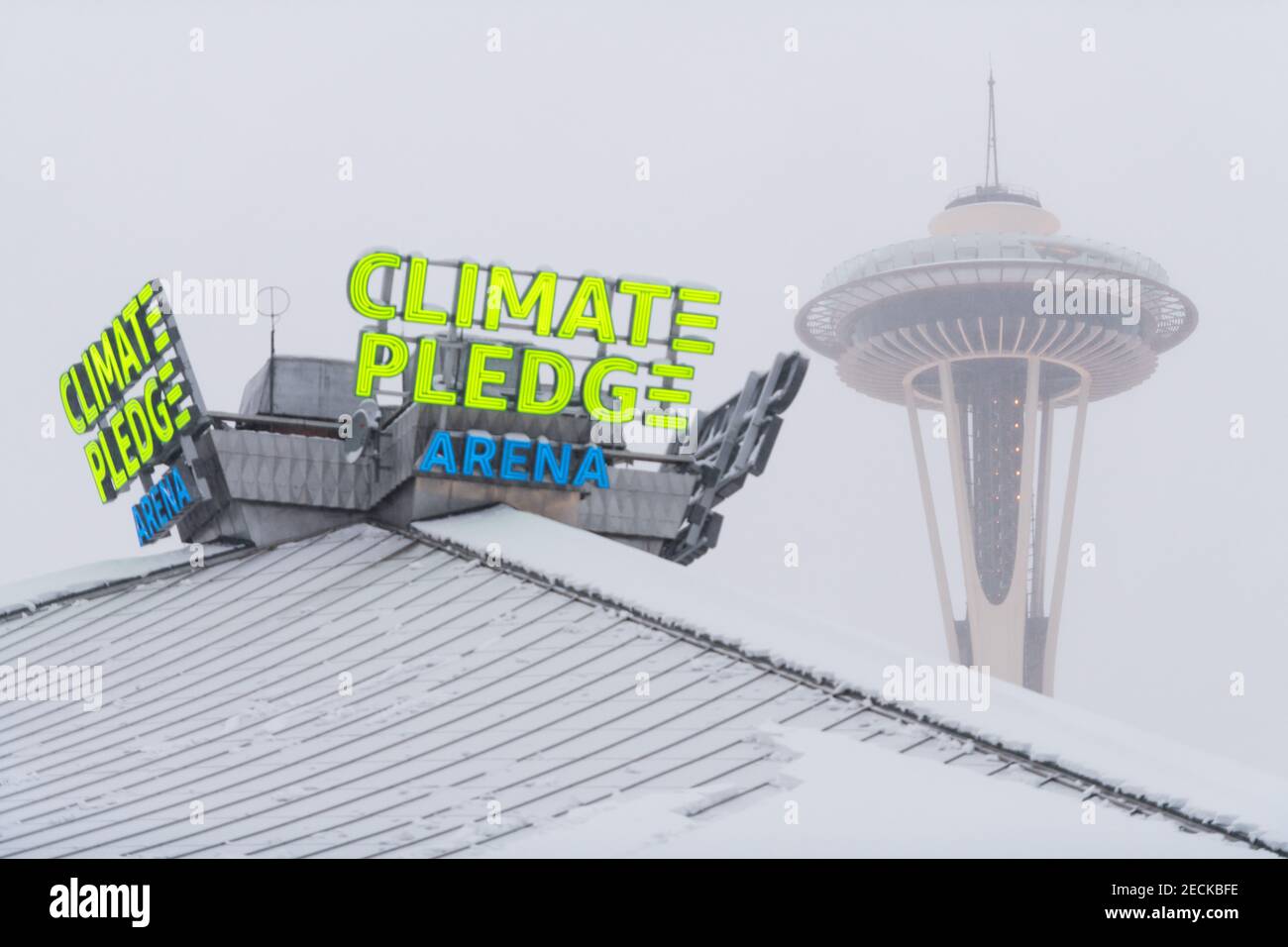 Seattle, Stati Uniti. 13 Feb 2021. A metà giornata, la nuova arena con pegno sul clima al neon a quattro lati, con la sua prima significativa caduta di neve. Jeff Bezos si è assicurato i diritti di denominazione della storica Key Arena, Amazon ha scelto di chiamarla Climate Pledge Arena anziché Amazon Arena. Come promemoria regolare dell'urgente necessità di un'azione sul clima. Credit: James Anderson/Alamy Live News Foto Stock