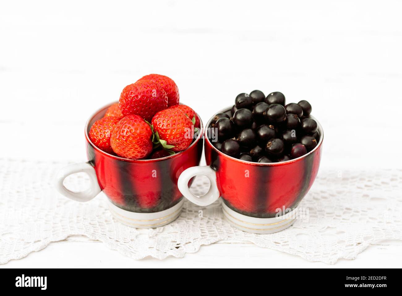 fragole e ribes nero in una tazza, estate di concetto nel villaggio Foto Stock