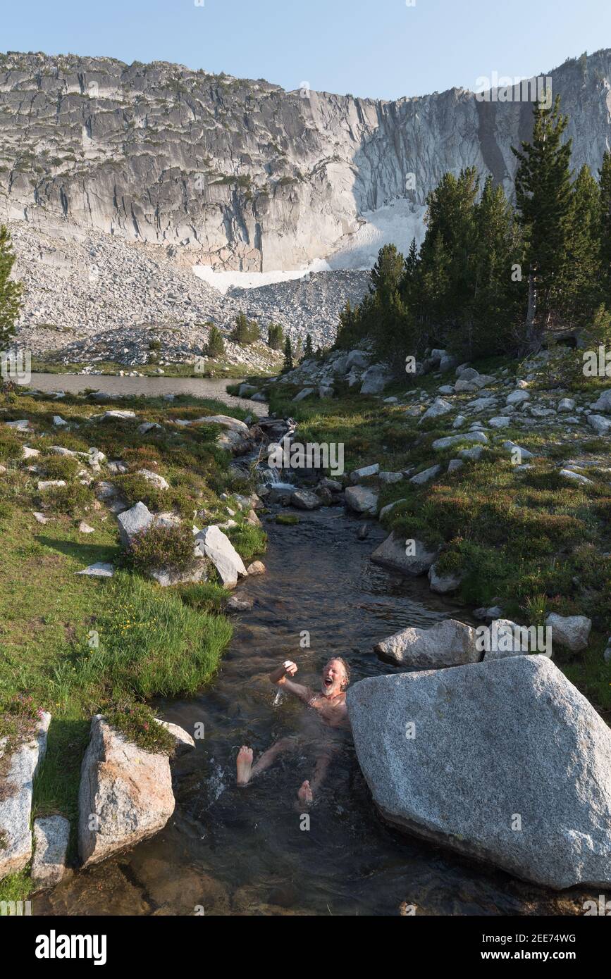 Escursionista che fa un tuffo in un ruscello freddo nelle Wallowa Mountains dell'Oregon. Foto Stock