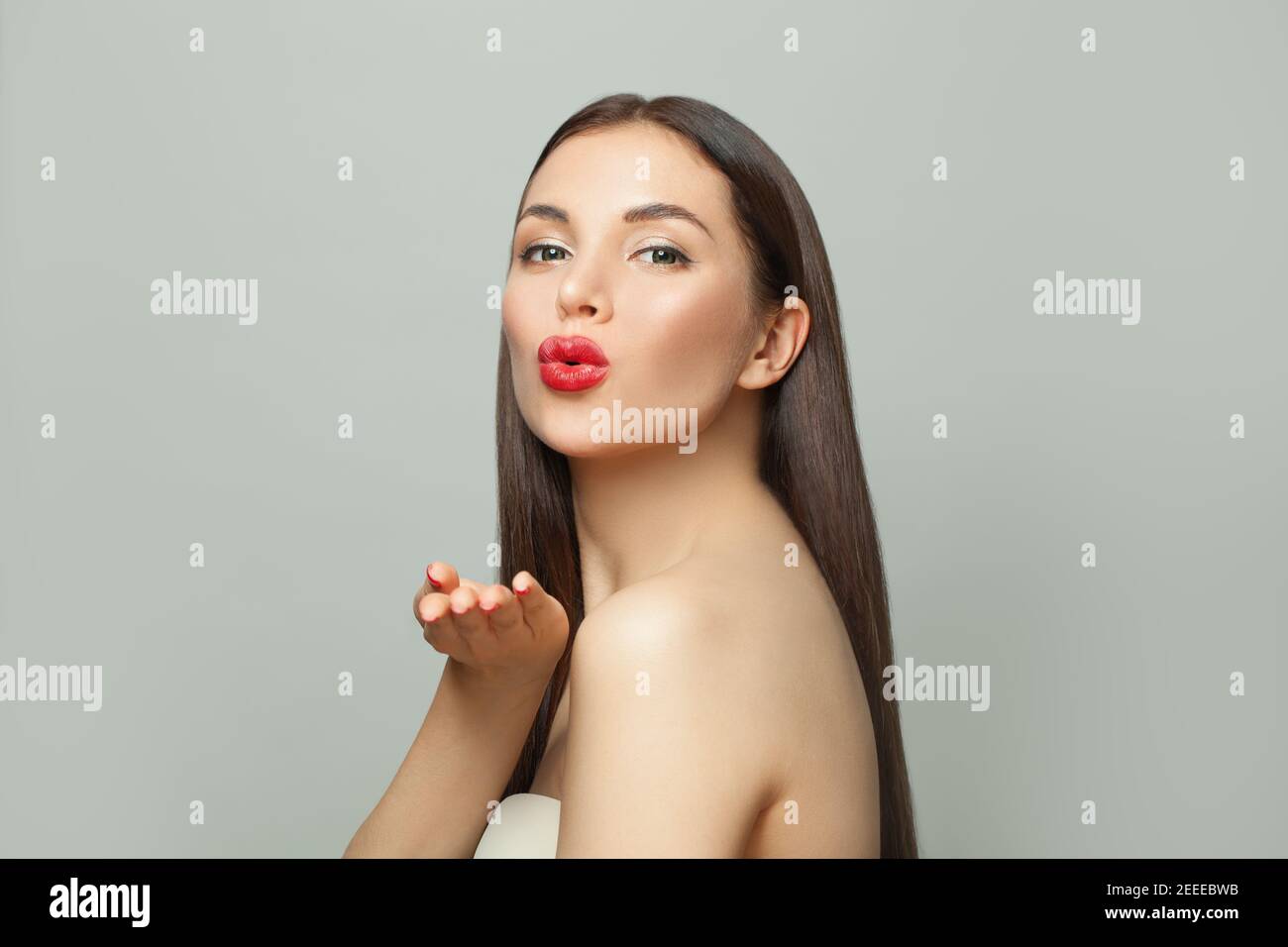Bella donna spa modello soffiare bacio su bianco. Concetto di cura della pelle e del viso Foto Stock
