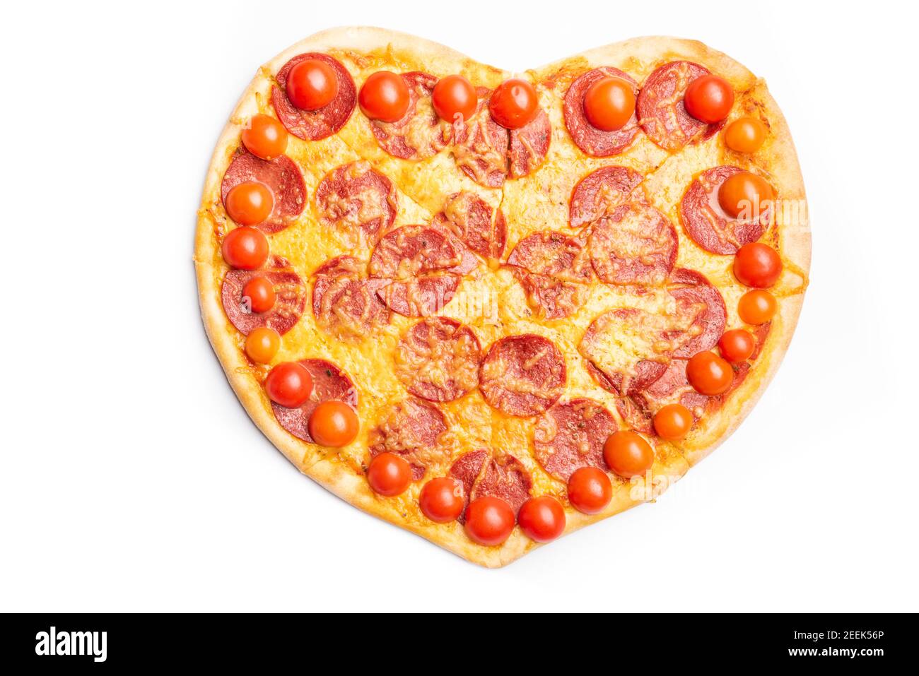 pizza fatta in casa a forma di cuore, con pepperoni, pomodori ciliegini, formaggio isolato su bianco, vista dall'alto. San Valentino, festa o vacanza roma Foto Stock