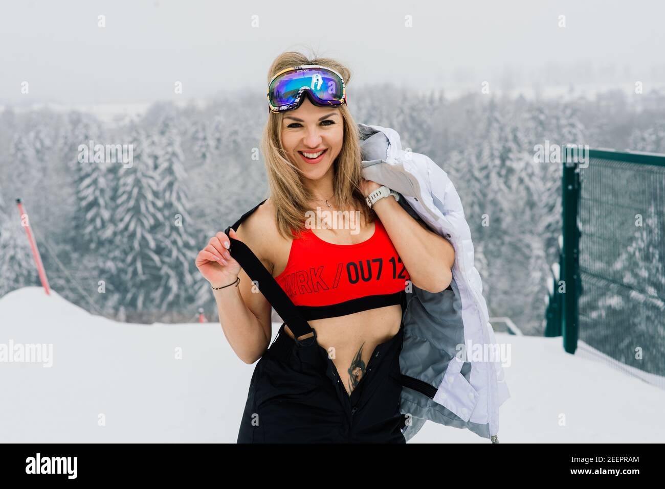 Happy ragazza snowboarder in posa in occhiali da sole con uno snowboard  Foto stock - Alamy
