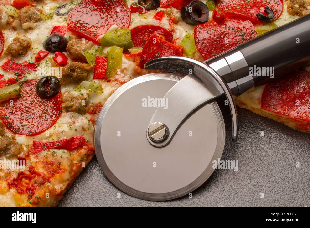 Fotografia alimentare, pizza con affettatrice per pizza Foto Stock