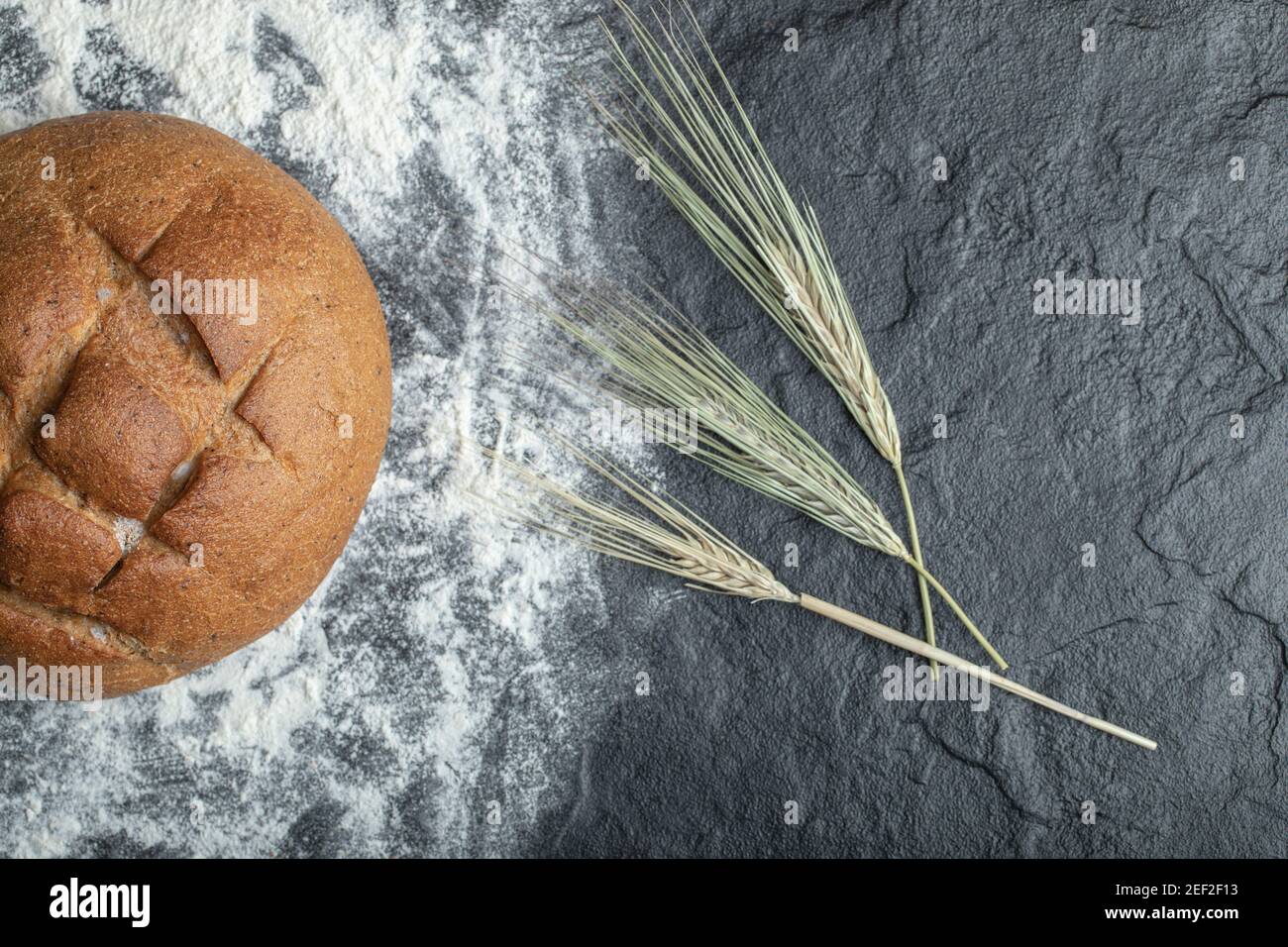 Pane di segale appena sfornato con ramificazione di grano Foto Stock