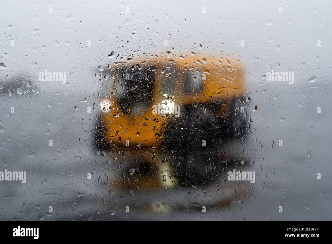 Vista su un veicolo giallo fuoristrada attraverso il vetro appannato Foto Stock