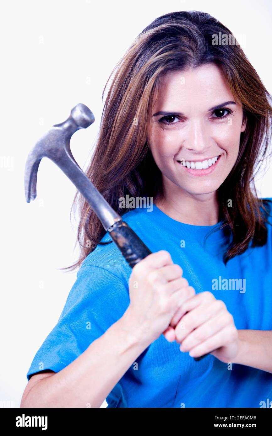 Ritratto di una giovane donna che tiene un martello Foto Stock