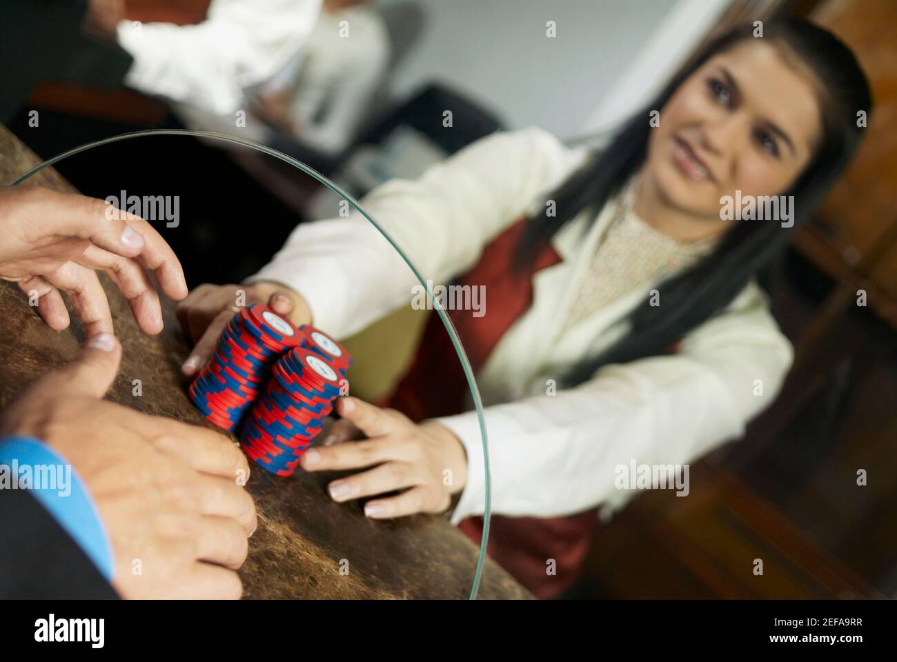 Lavoratore di casinò che dà chip di gioco ad un uomo al banco cassa di un casinò Foto Stock