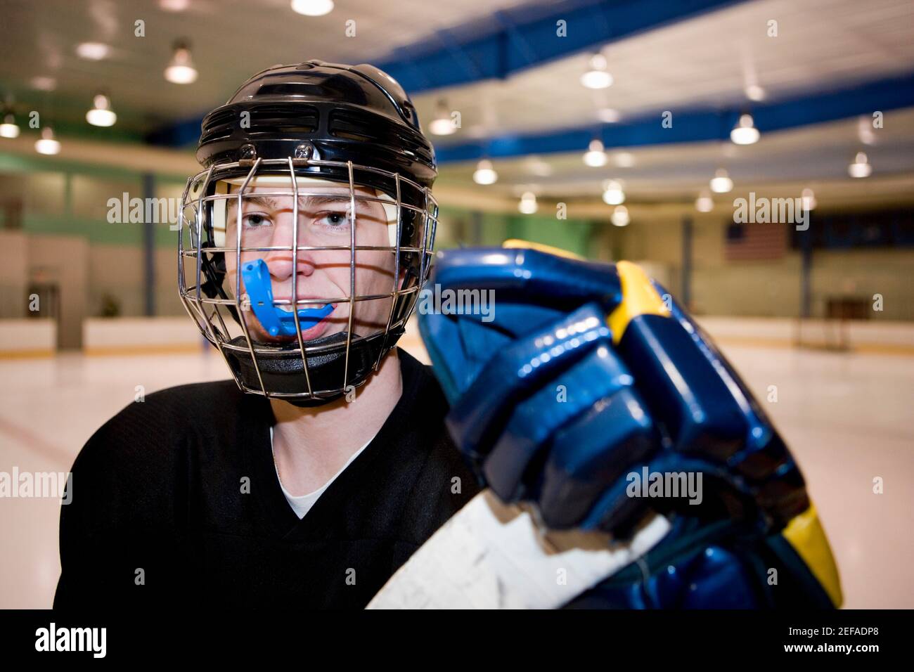 Ritratto di un giocatore di hockey su ghiaccio nella pista di pattinaggio Foto Stock