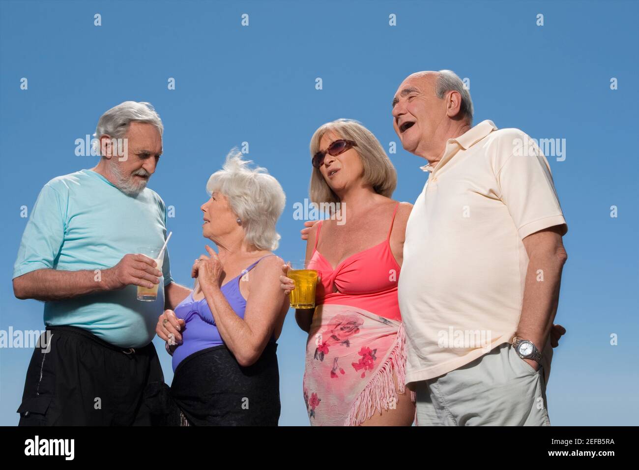 Vista ad angolo basso di due coppie anziane che si levano insieme Foto Stock