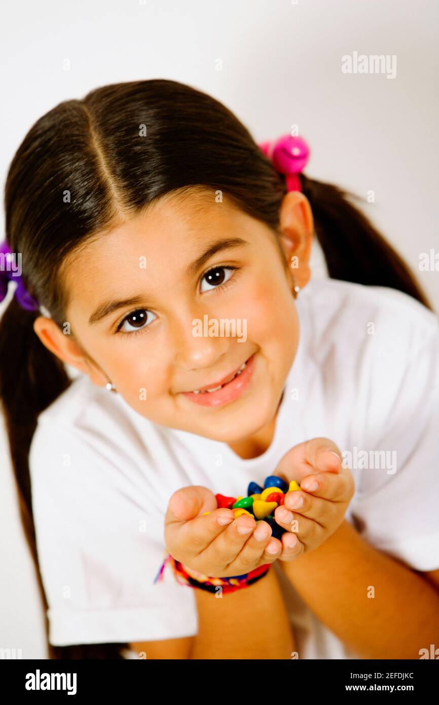 Ritratto di una ragazza che tiene le caramelle nelle mani Foto Stock