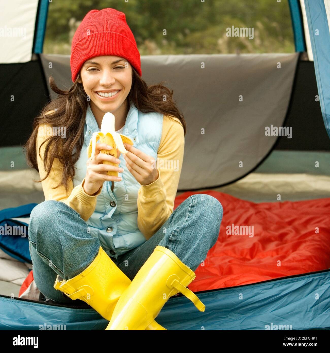 Ritratto di una giovane donna che spellava una banana Foto Stock