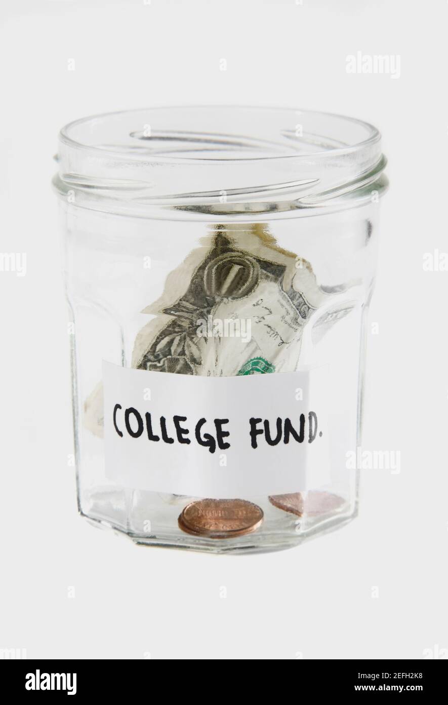 Dollari bollette e monete in un vaso Foto Stock