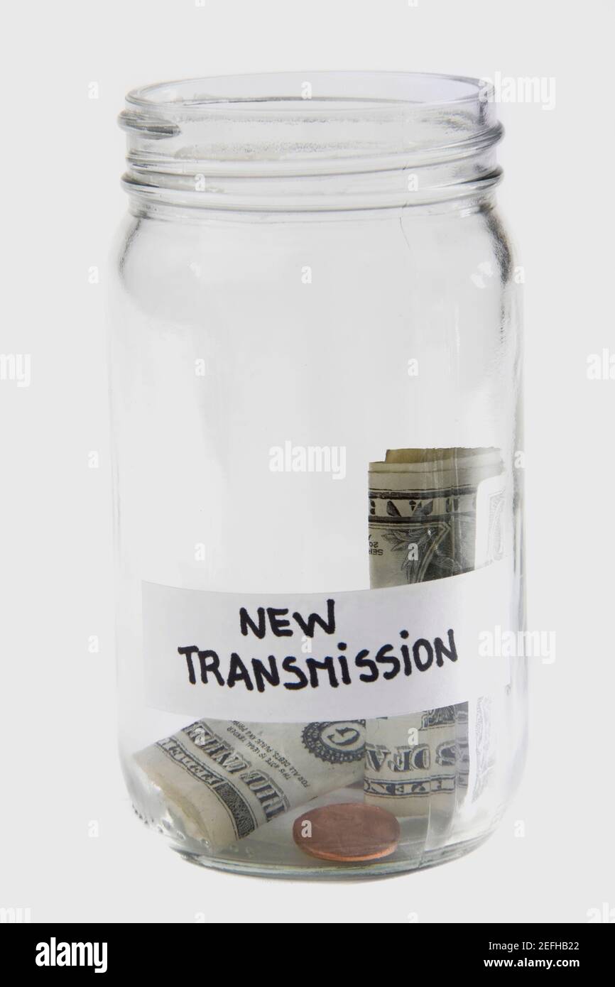 Dollari bollette e monete in un vaso Foto Stock