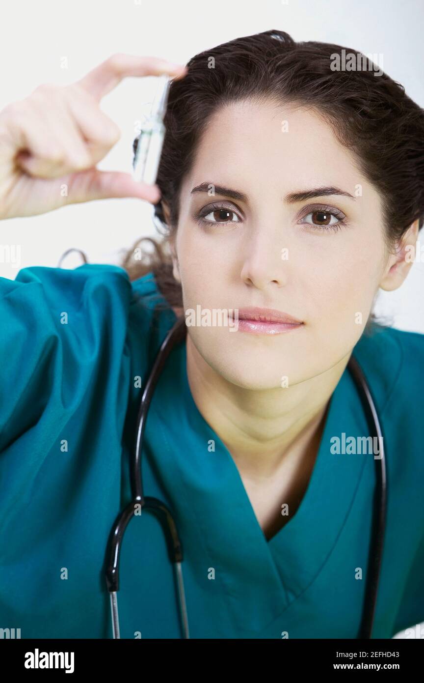 Close up di un medico femminile che tiene un flaconcino Foto Stock