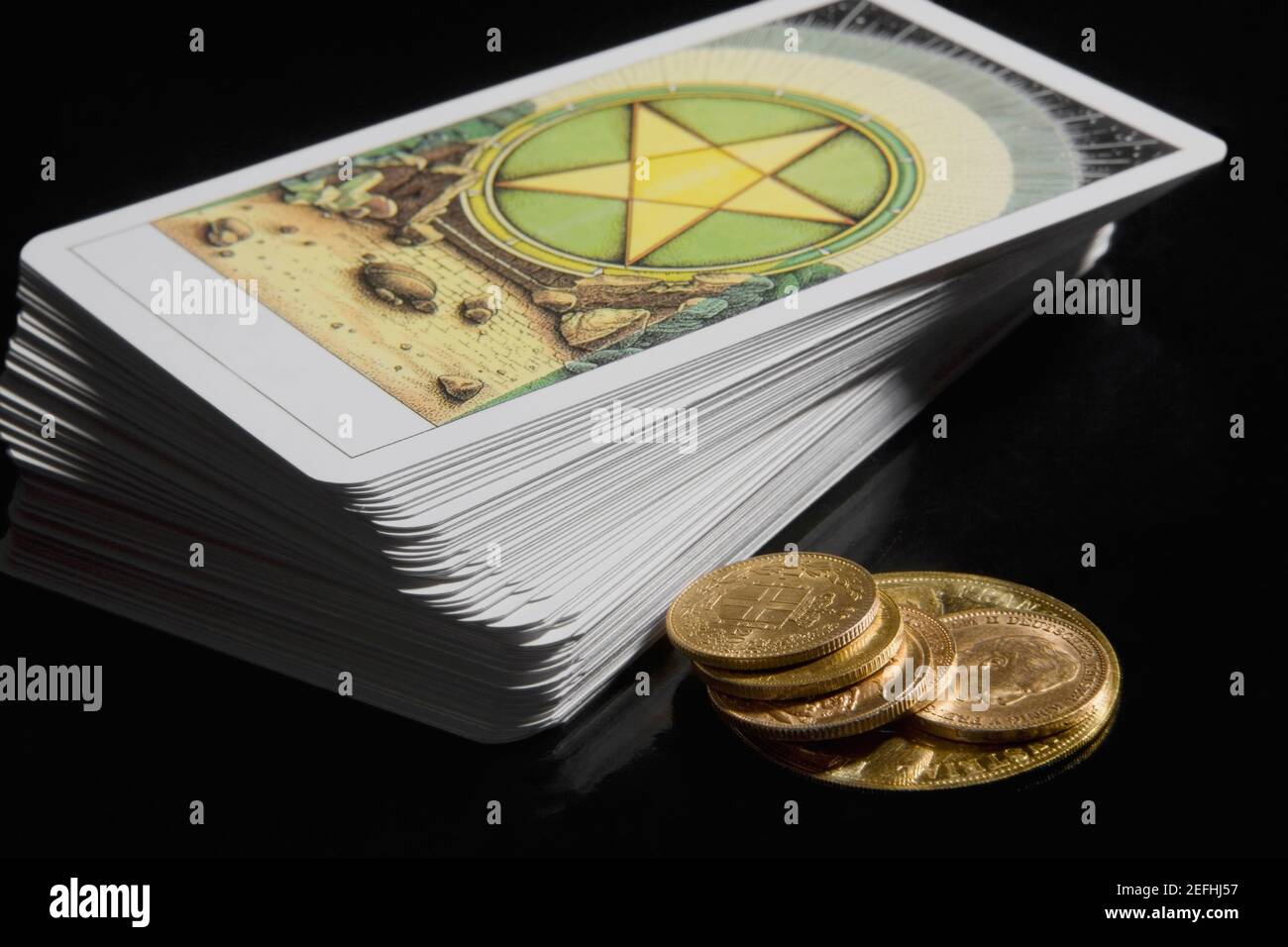 Primo piano di una pila di carte tarocchi con monete Foto Stock