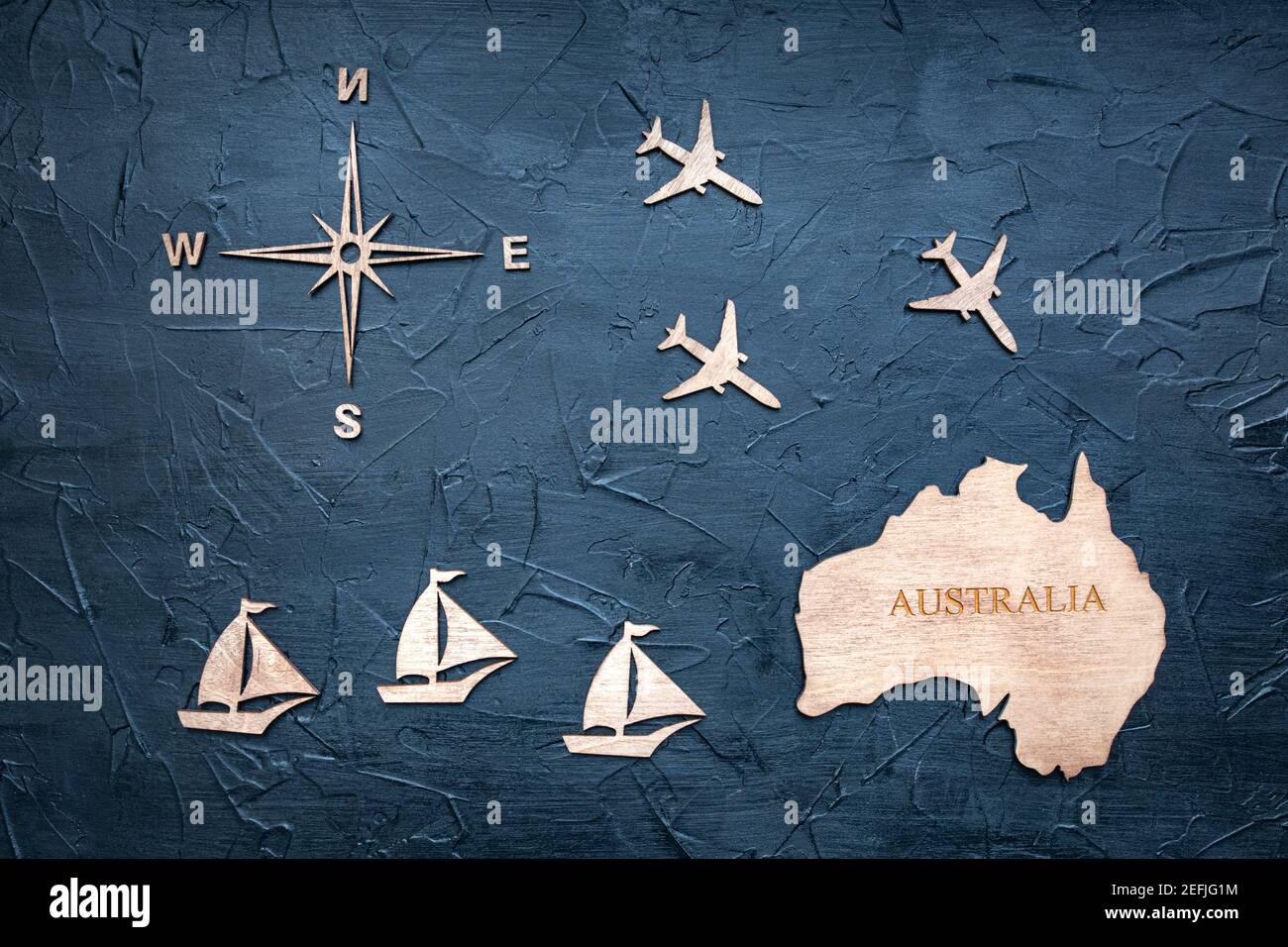 Figurine di legno sul tema del viaggio in Australia su uno sfondo testurizzato. Foto Stock