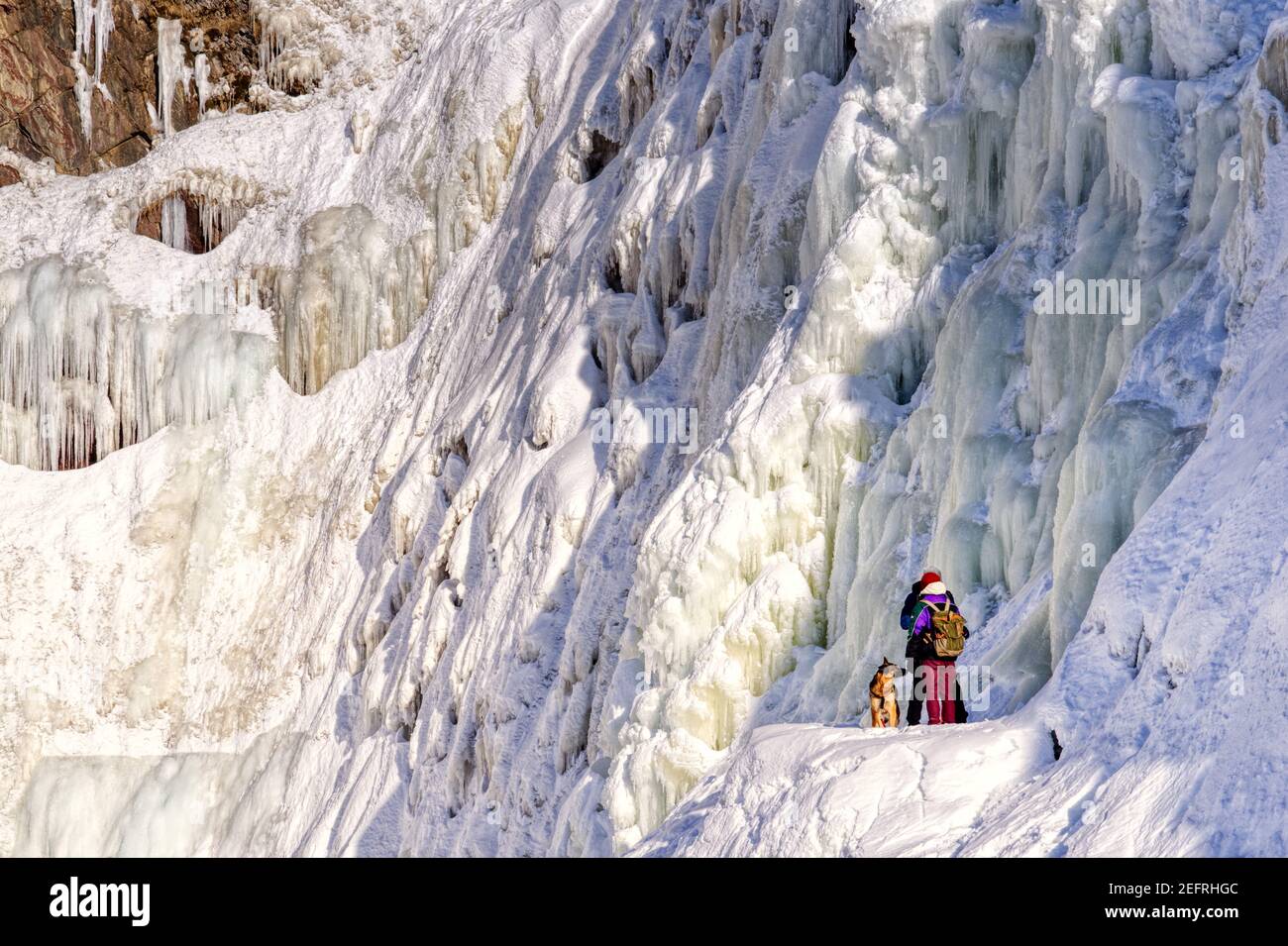 Due persone con il loro cane al Frozen Chutes de Chaudière a Charny vicino Quebec City, Canada Foto Stock
