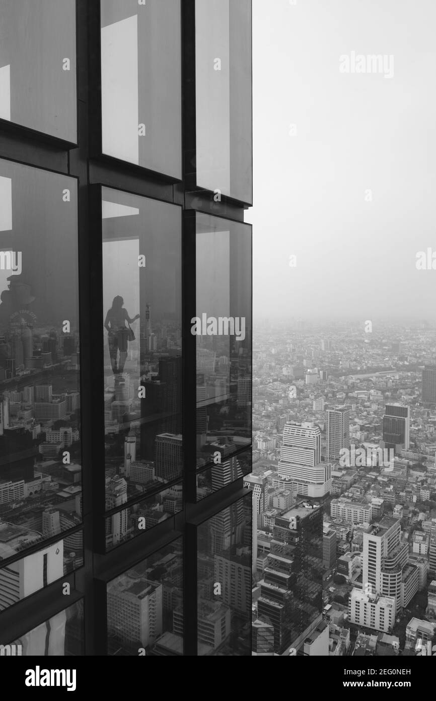 Donna si affaccia sulla città di Bangkok dalla Mahanakhon Tower a Bangkok Thailandia, in bianco e nero. Foto Stock