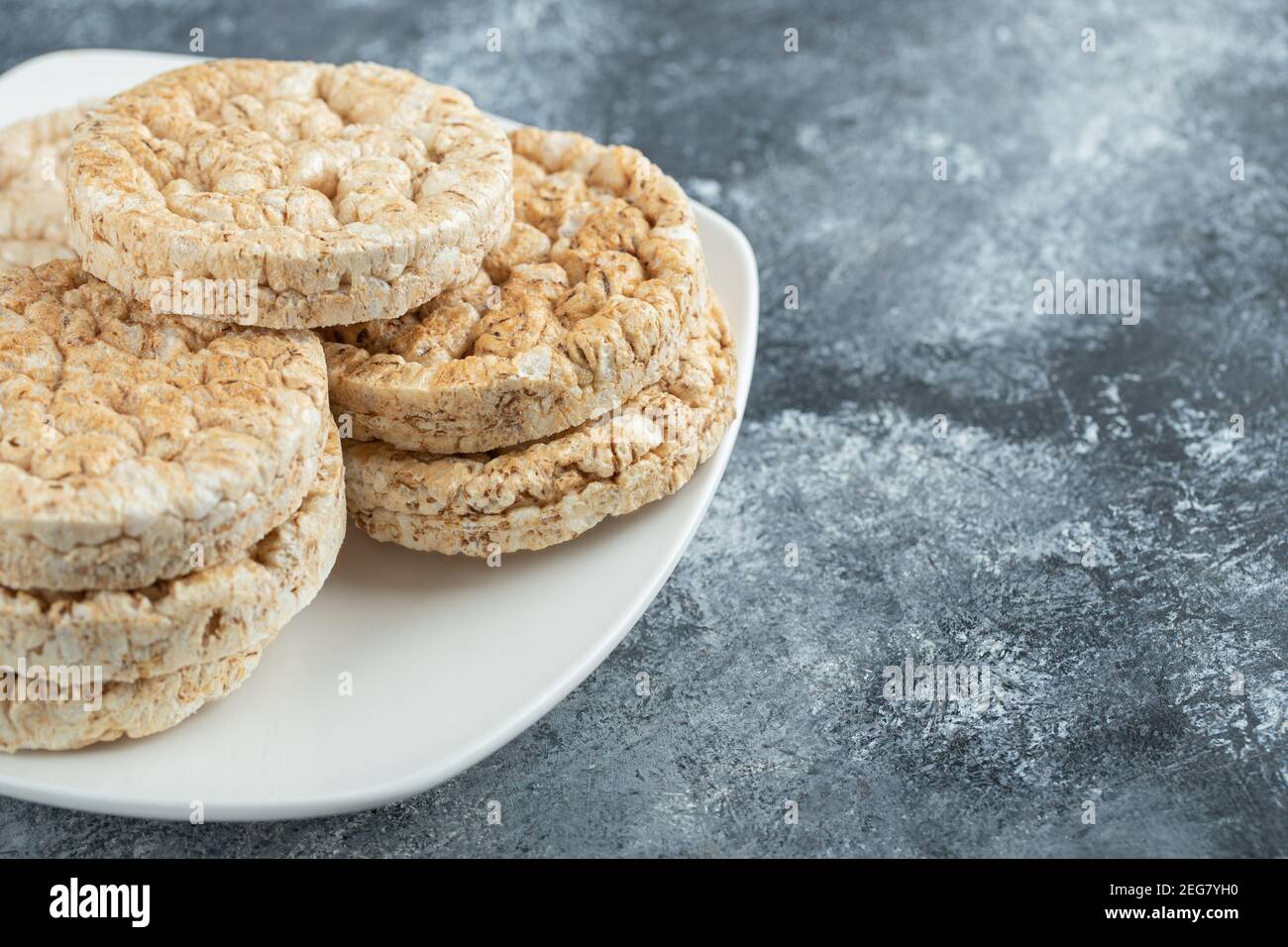 Torte di riso croccanti su un bel piatto bianco Foto Stock