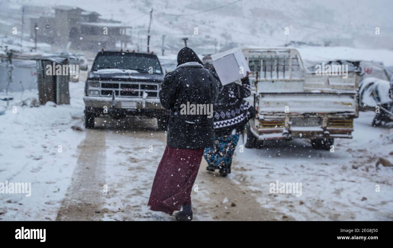 Uomo e donna dei rifugiati siriani a Beqaa del Libano a. La Siria confina con il campo di rifugio ricevendo donazioni aiuta dopo Blizzard in Arsal Foto Stock