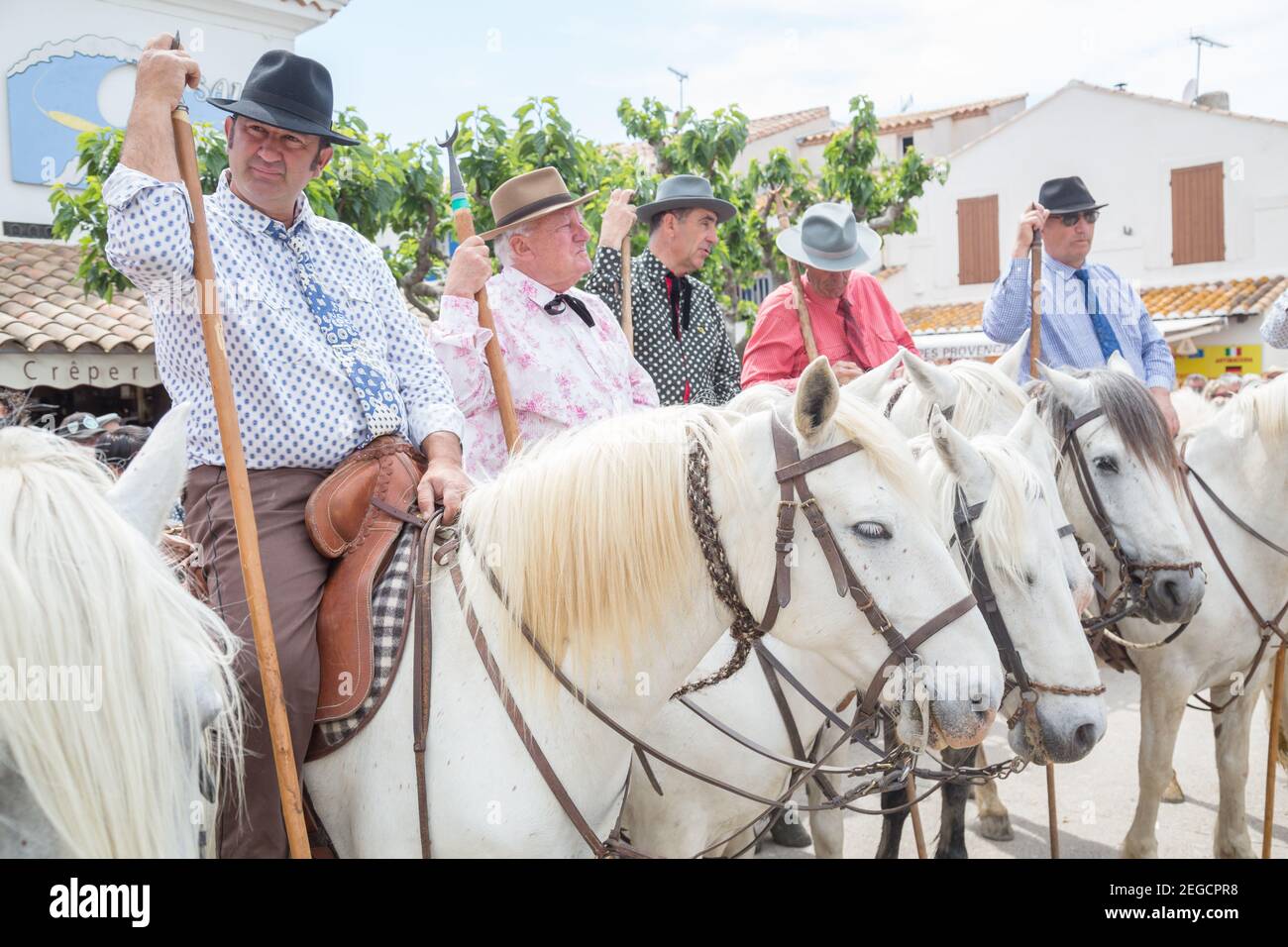 'Les Gardiens Camargaises', in cima ai loro cavalli Camargue aspettare fuori della Chiesa di Saintes Marie de la Mer per la fine del servizio della chiesa e la prosce Foto Stock