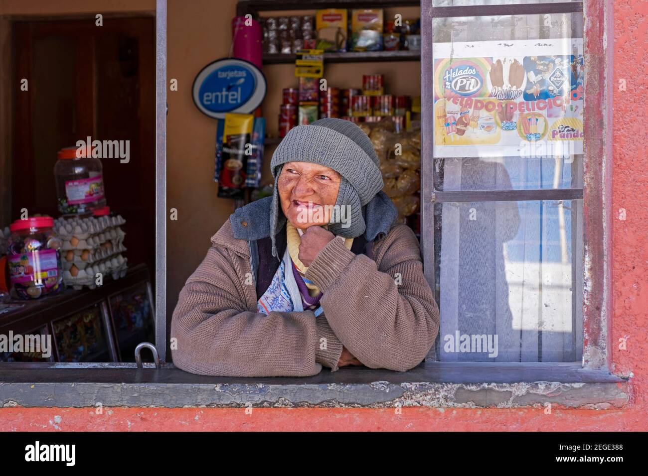Anziana donna boliviana, venditrice femminile che guarda attraverso la vetrina nella città di Uyuni, provincia di Antonio Quijarro, Dipartimento di Potosí, Bolivia Foto Stock
